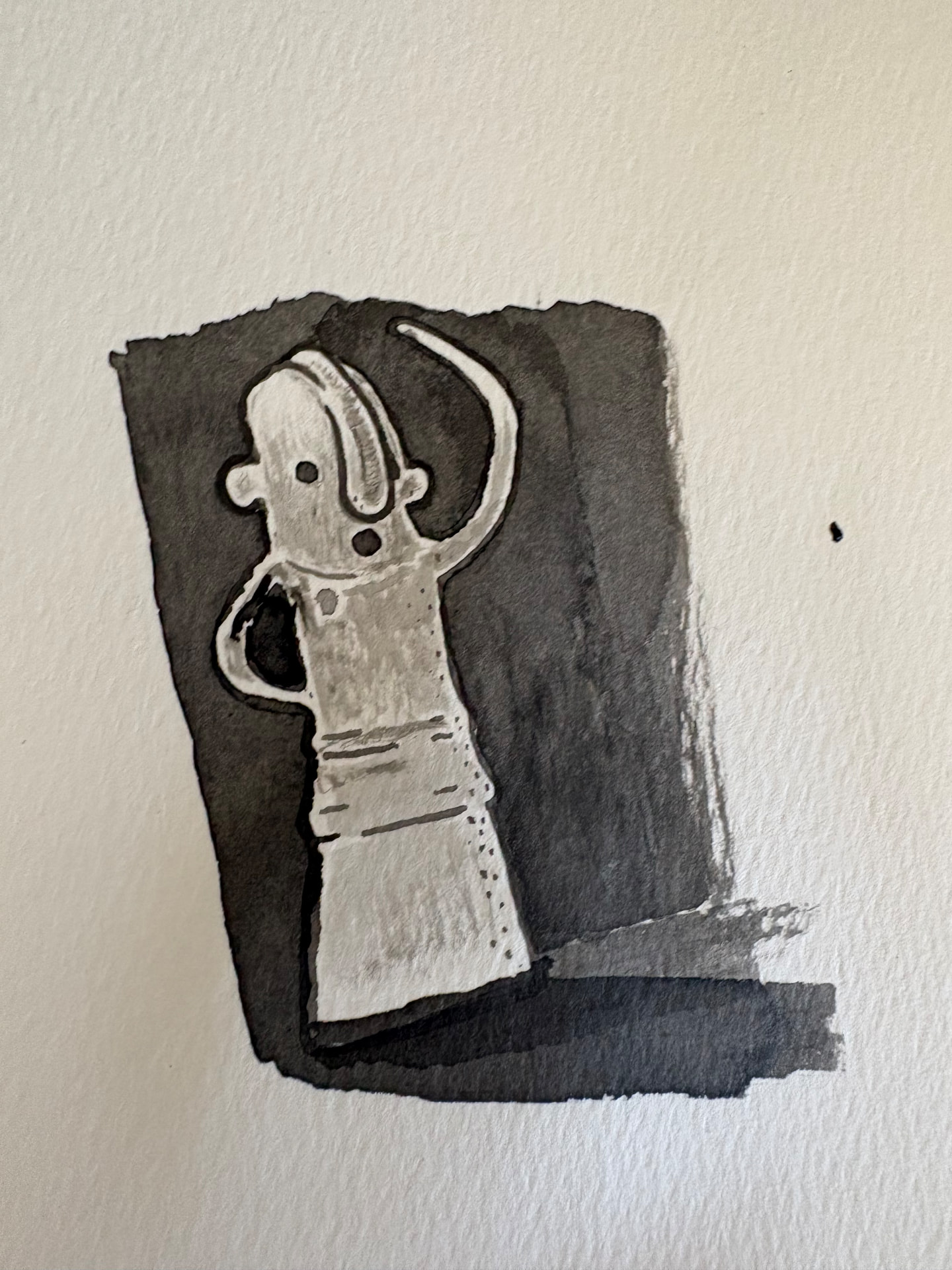 Ink-wash drawing of a haniwa — a small standing figure holding its shape against a dark background